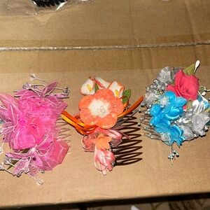 3 handmade floral hair pieces made with decorative occasion flowers